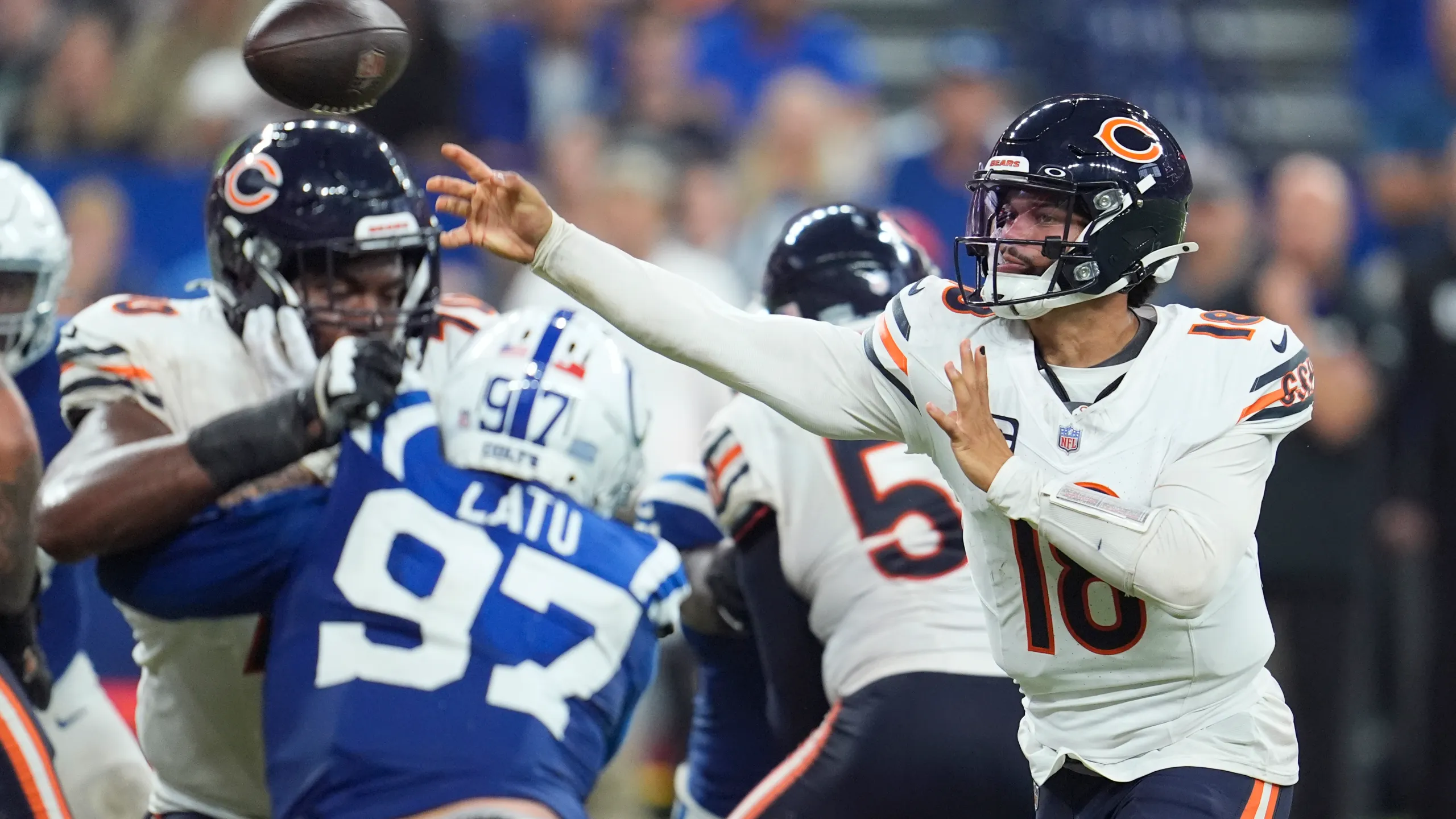 Chicago Bears QB Caleb Williams throwing football with Colts rookie Laiatu Latu pressuring the QB