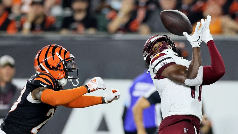 a football player in a uniform catching a football